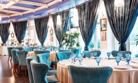 restaurant-hall-with-blue-chairs-blue-glasses-table_140725-8027